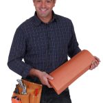 Smiling roofer standing on white background